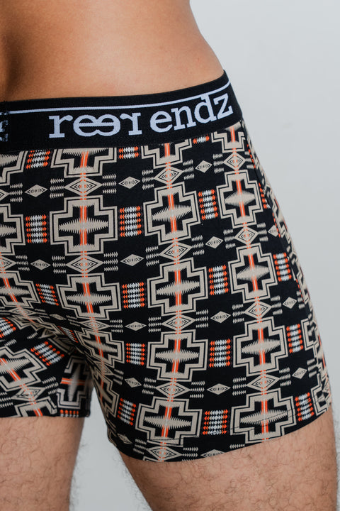 Male model showcasing Reer Endz organic cotton fly front trunk in Zephyr print